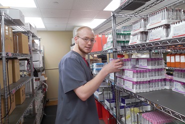 MFP participant - Devin working in laboratory stockroom